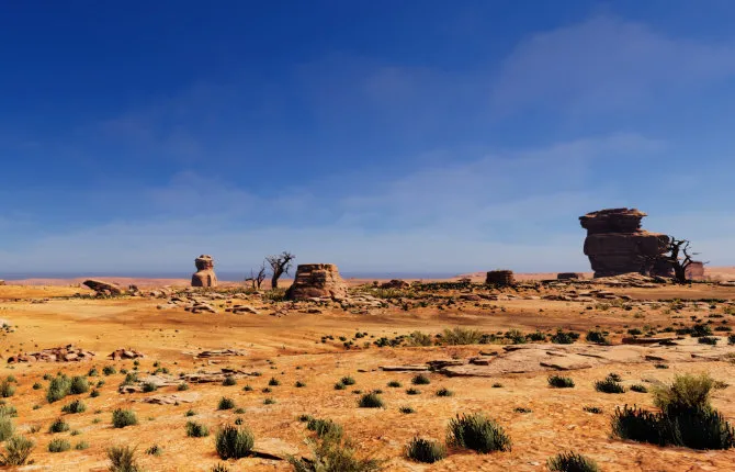 Desert landscape with sandstone formations beneath a blue sky